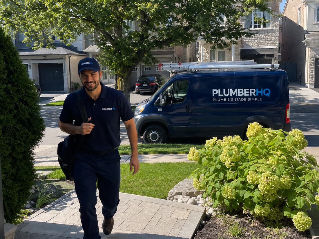 A friendly PlumberHQ plumber arriving at a customer home